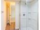 Modern bathroom with a large shower and wood-look floors at 1537 Excalibur St, Holiday, FL 34690
