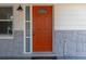 Bright orange front door adds a pop of color at 1537 Excalibur St, Holiday, FL 34690