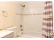 Clean bathroom with tub, shower, and updated tile at 1537 Excalibur St, Holiday, FL 34690