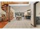 Open concept dining room with large table and spiral staircase at 223 S Riverhills Dr, Temple Terrace, FL 33617