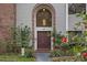 Inviting front entrance with double doors and arched window at 223 S Riverhills Dr, Temple Terrace, FL 33617