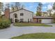 Two-story house with brick and siding, large driveway and a landscaped yard at 223 S Riverhills Dr, Temple Terrace, FL 33617