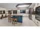 Updated kitchen with island, stainless steel appliances, and blue cabinets at 223 S Riverhills Dr, Temple Terrace, FL 33617
