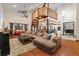 Spacious living room with spiral staircase, hardwood floors, and a cozy seating area at 223 S Riverhills Dr, Temple Terrace, FL 33617