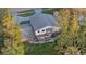 Aerial view shows a house with a large deck and surrounding trees at 223 S Riverhills Dr, Temple Terrace, FL 33617