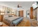 Main bedroom with a king-size bed, bench, and access to a bathroom at 223 S Riverhills Dr, Temple Terrace, FL 33617