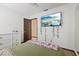 Bedroom with a double bed, wall-mounted TV, and dresser at 223 S Riverhills Dr, Temple Terrace, FL 33617