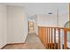 Upstairs hallway with carpeted floor and wooden railing at 223 S Riverhills Dr, Temple Terrace, FL 33617