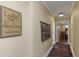 Hallway with hardwood floors, wall art, and a door to a bedroom at 255 16Th Ne Ave, St Petersburg, FL 33704