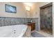 Bathroom with soaking tub and walk-in shower with stone tile at 255 16Th Ne Ave, St Petersburg, FL 33704