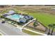 Aerial view of community pool, playground, and surrounding landscape at 28732 Rambutan Dr, Wesley Chapel, FL 33543