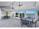 Covered outdoor patio with tables and chairs, overlooking a lake at 28732 Rambutan Dr, Wesley Chapel, FL 33543