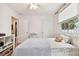 Cozy bedroom featuring a metal bed frame and hardwood floors at 311 N Bradford Ave, Tampa, FL 33609