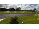 Community features a pond, lush landscaping, and paved pathways at 37611 Amigo Dr, Zephyrhills, FL 33541