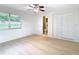 Bright bedroom with wood-look floors, large closet, and ensuite bathroom at 6269 Skyline Ct, Spring Hill, FL 34606