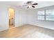 Bright bedroom with wood-look floors, en-suite bathroom, and spacious closet at 6269 Skyline Ct, Spring Hill, FL 34606