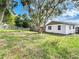 Large backyard with grassy area and mature trees at 6269 Skyline Ct, Spring Hill, FL 34606