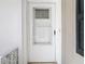 White front door with glass panel and updated hardware at 6269 Skyline Ct, Spring Hill, FL 34606