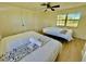 Cozy bedroom with two twin beds, ceiling fan, and ample natural light at 6269 Skyline Ct, Spring Hill, FL 34606