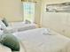 Bright bedroom featuring two beds, soft pillows and plenty of natural light at 6269 Skyline Ct, Spring Hill, FL 34606