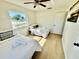 Sunlit bedroom with two beds, light wood floors and neutral decor at 6269 Skyline Ct, Spring Hill, FL 34606