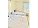 Bright bedroom featuring two twin beds with crisp white linens and plenty of natural light at 6269 Skyline Ct, Spring Hill, FL 34606