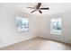 Bedroom with two windows, ceiling fan, and light floors at 6269 Skyline Ct, Spring Hill, FL 34606