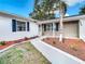 Inviting front porch entry with newly paved walkway and updated landscaping at 6269 Skyline Ct, Spring Hill, FL 34606