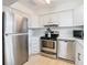 Modern kitchen with stainless steel appliances and white cabinets at 6269 Skyline Ct, Spring Hill, FL 34606