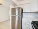 Stainless steel refrigerator in a kitchen with white cabinets and countertops at 6269 Skyline Ct, Spring Hill, FL 34606