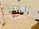 Bright living room with modern flooring, large window, and stylish brown leather sectional at 6269 Skyline Ct, Spring Hill, FL 34606