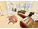 Bright living room with modern flooring, large window, and stylish brown leather sectional at 6269 Skyline Ct, Spring Hill, FL 34606