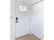 Modern white front door with keyless entry and storage at 6269 Skyline Ct, Spring Hill, FL 34606
