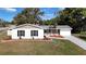 Newly renovated home with a landscaped lawn and a modern facade at 6269 Skyline Ct, Spring Hill, FL 34606