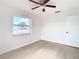 Well-lit bedroom featuring light flooring and a ceiling fan at 6269 Skyline Ct, Spring Hill, FL 34606
