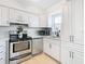 Modern kitchen with white cabinets, stainless steel appliances, and quartz countertops at 6269 Skyline Ct, Spring Hill, FL 34606