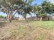 Large fenced backyard with mature trees and grassy area at 6269 Skyline Ct, Spring Hill, FL 34606
