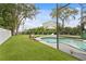 Relaxing pool area with artificial turf and a screened enclosure at 715 S Himes Ave, Tampa, FL 33609