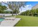 Pool area with lounge chairs and tropical landscaping at 715 S Himes Ave, Tampa, FL 33609