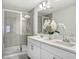 Well-lit bathroom features double vanity with modern fixtures and glass shower at 11714 Blackbrook Ct, Seffner, FL 33584