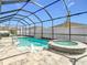 Inviting screened pool and spa with waterfall feature at 13444 Golden Lime Ave, Spring Hill, FL 34609