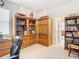 Spacious home office with ample built-in shelving and a view to another room at 13444 Golden Lime Ave, Spring Hill, FL 34609