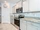 Modern kitchen with stainless steel appliances and granite countertops at 13444 Golden Lime Ave, Spring Hill, FL 34609