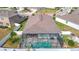 Aerial view of house with pool and surrounding houses at 13444 Golden Lime Ave, Spring Hill, FL 34609