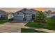 Two-story house with gray siding and a palm tree at 13444 Golden Lime Ave, Spring Hill, FL 34609
