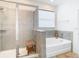 Bathroom with shower and tub combination, and a window at 13444 Golden Lime Ave, Spring Hill, FL 34609