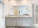 Elegant bathroom with double sinks, granite countertop, and large shower at 13444 Golden Lime Ave, Spring Hill, FL 34609
