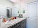 Bathroom with double vanity, granite countertop, and decorative accents at 13444 Golden Lime Ave, Spring Hill, FL 34609