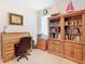 Home office with built-in bookcases and a large desk at 13444 Golden Lime Ave, Spring Hill, FL 34609