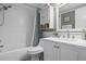 Updated bathroom with a tub, white vanity, and marble countertop at 236 Caryl Way # 16, Oldsmar, FL 34677